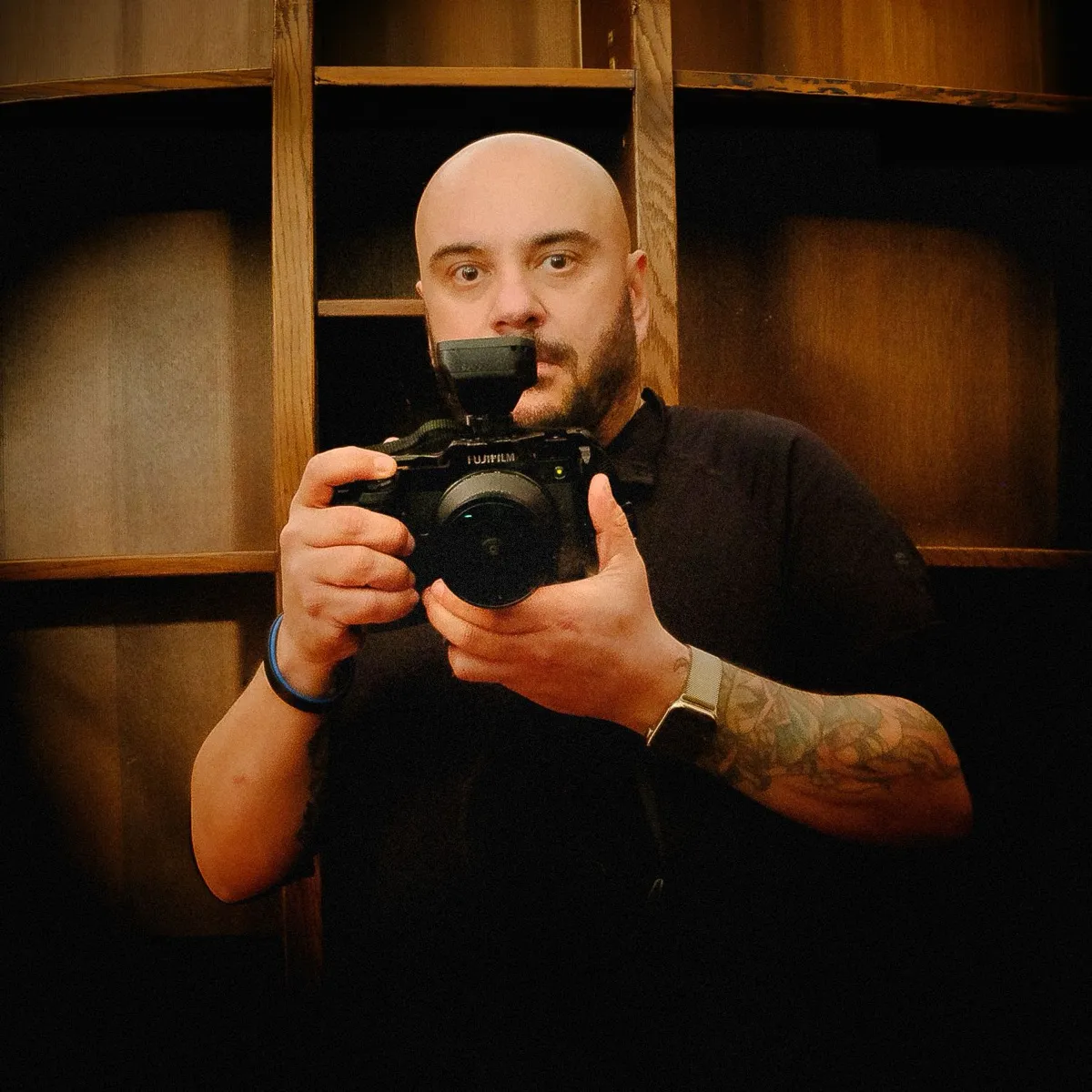John LaCroix holding a Fujifilm camera with a flash trigger